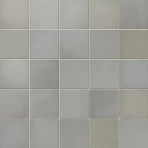 Soft pebble-inspired 5x5 matte ceramic tiles in a soothing mix of gray and green tones, perfect for serene spaces