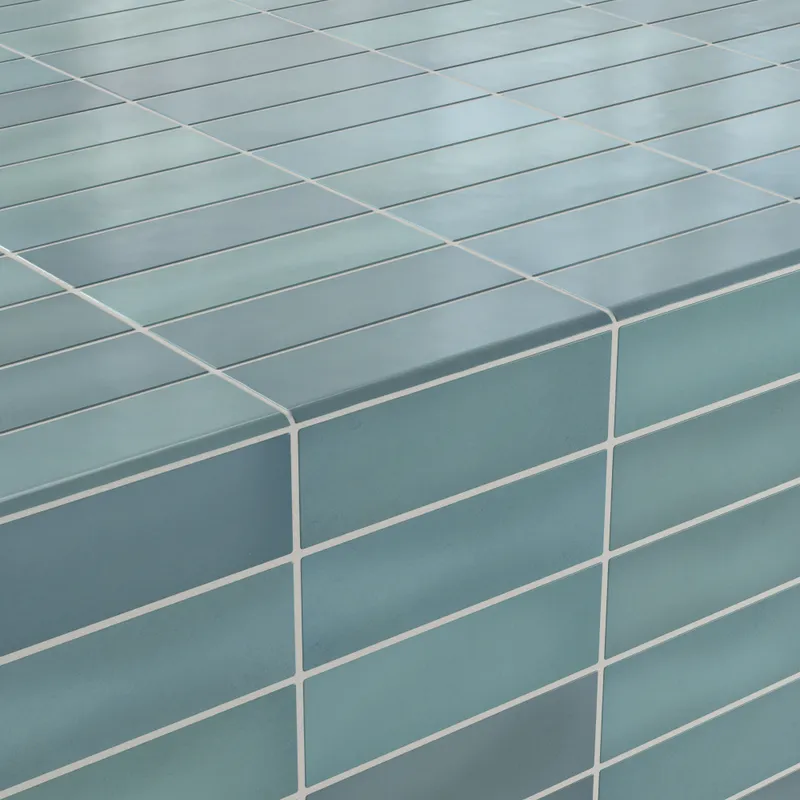 Teal bullnose tiles with a matte finish, elegantly curving over a corner for a polished edge detail