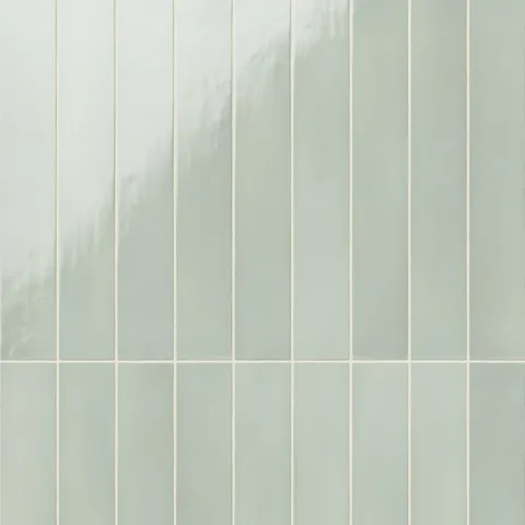 Pistachio green ceramic subway tiles featuring a sleek, vertical layout and a lightly glossy surface