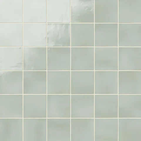 Soft pistachio green 4x4 square ceramic tiles with a subtle glossy finish, perfect for creating a calming and fresh ambiance