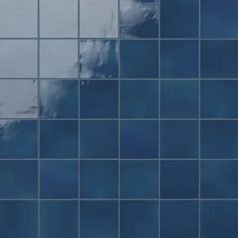 Deep cobalt blue 4x4 ceramic square tiles with a glossy finish, creating a vibrant and rich aesthetic for walls or surfaces