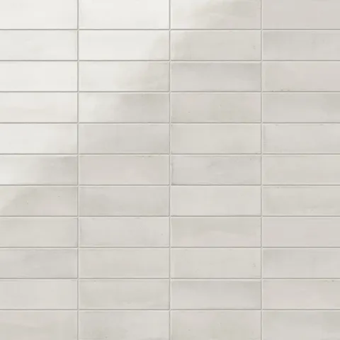A 2x6 porcelain subway tile in creamy white, featuring a glossy finish, and a clean stacked layout with fine grout lines.