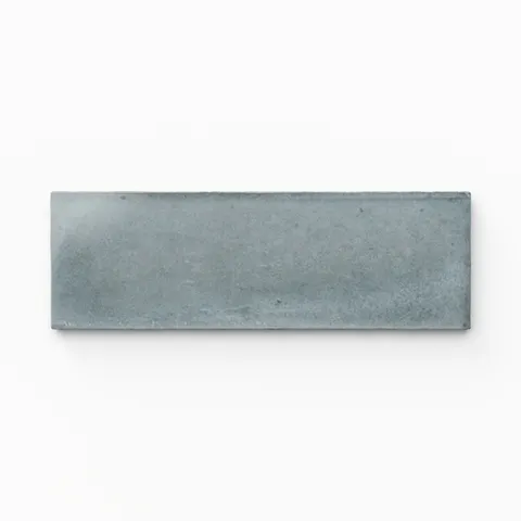 A 2x6 porcelain tile in light blue, featuring a glossy finish, soft tonal variation, and a clean, flat-edge profile.