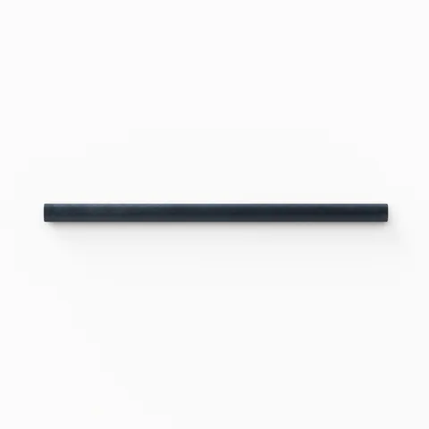 A 0.5x8 ceramic tile trim in navy blue, featuring a matte finish, and softly curved profile for elegant edging.
