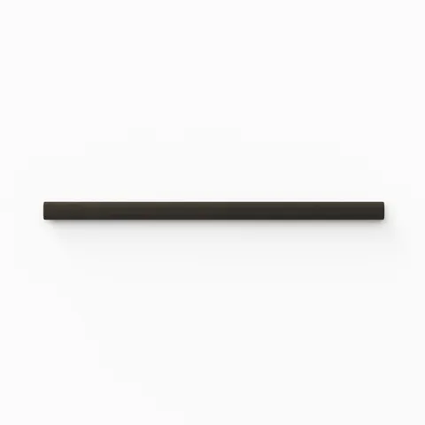 A 0.5x8 ceramic tile trim in charcoal black, featuring a glossy finish, and softly curved profile for elegant edging.