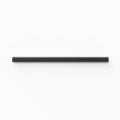 A 0.5x8 ceramic tile trim in charcoal black, featuring a matte finish, and softly curved profile for elegant edging.