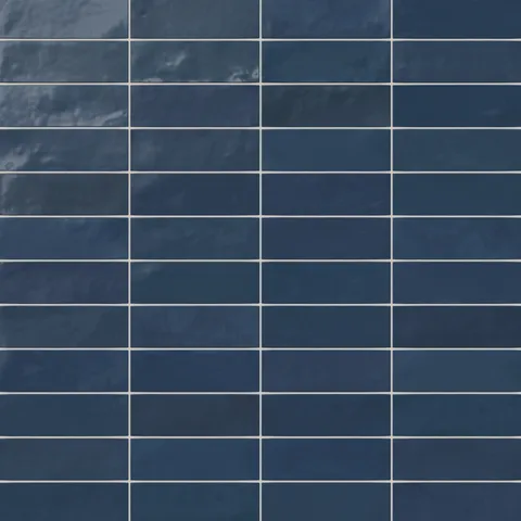 A 2x6.3 ceramic subway tile in dark blue, featuring a glossy finish, and a clean stacked layout with fine grout lines.