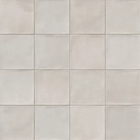 A 5.5x5.5 porcelain grid square tile in soft cool gray, featuring a matte finish, and a handcrafted, subtly textured surface.