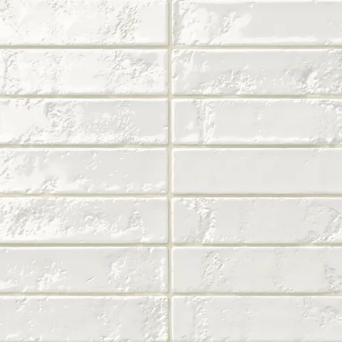 Glossy white 2x10 ceramic subway tile with a slightly textured, uneven surface that adds depth and handcrafted character to the finish.