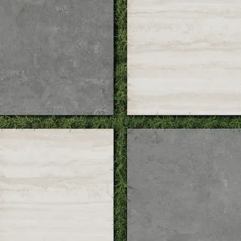Large format porcelain pavers in dark gray and beige set in grass, featuring a stone look checkerboard design with bold scale and natural texture.