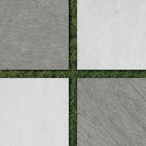 Outdoor checkerboard layout of 24x24 stone-look porcelain paver tiles in gray and white tones, set over grass for a striking yet natural patio design