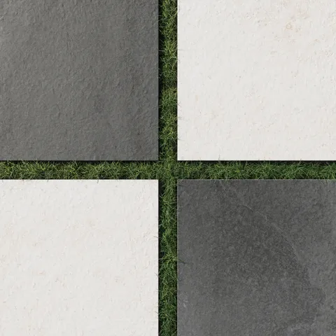 Checkerboard layout of porcelain pavers featuring deep charcoal gray and warm canvas tones, paired over trimmed grass for a clean, outdoor-ready contrast.