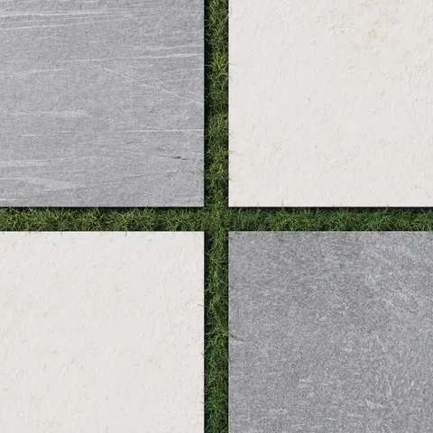 Bowden 24x24 porcelain pavers in slate gray and canvas white, arranged in a checkerboard pattern on grass, showing a textured matte surface with a natural stone feel.