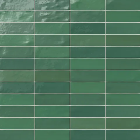 Glossy ceramic 2x8 subway tile in rich emerald green, featuring a handcrafted look with subtle surface variations for added depth and character.