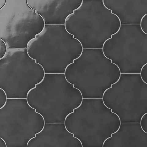 Charcoal gray glossy porcelain lantern tile with a repeating Moroccan-inspired shape, smooth surface texture, and light grout contrast.