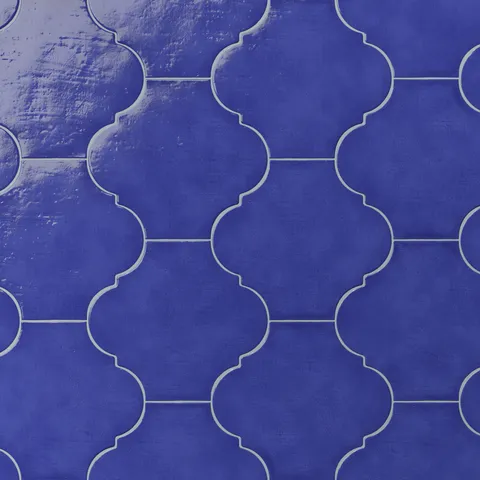 Glossy cobalt blue porcelain lantern tile featuring a repeating Moroccan-style pattern, gentle surface texture, and crisp grout lines.