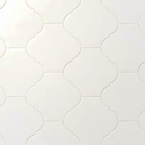 White glossy porcelain lantern tile with a repeating Moroccan-inspired pattern, subtle surface texture, and soft grout lines.