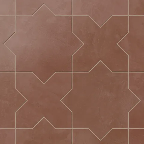 Defined by star and cross geometry, our Isabel 11x11 Matte Porcelain Tile in Rust uses layered red hues and subtle cement texture for an architectural look ideal for Spanish-style spaces.