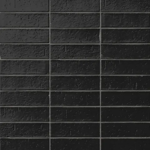 Handmade brick tiles with a gleaming black glaze, subtle dimples, pinholes, and organic surface variation.