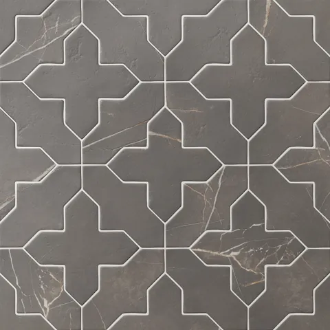 Star and cross–shaped porcelain tiles in dark gray show gentle veining and a matte finish, forming a balanced pattern that feels composed and quietly textured.