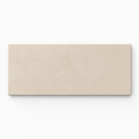 Isabel 2.5x12 Matte Porcelain Tile in Cream highlights earth-drawn grayish-beige hues, an elongated subway profile, and fine cement-plaster texture softened by a powdery matte glaze.