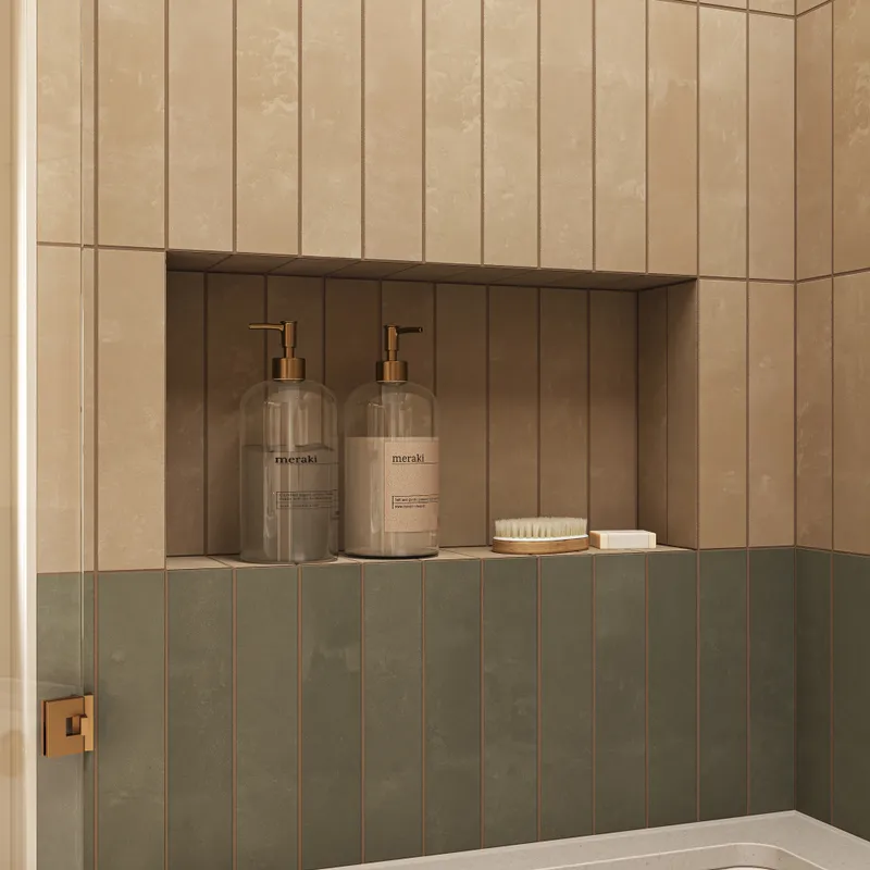 This shower wall features warm beige porcelain subway tiles set vertically, with gentle color movement that adds depth while keeping the space calm and well balanced.