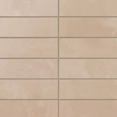 Beige 2x6 porcelain subway tiles feature gentle, earth-drawn variation and a powdery matte surface, where soft pink undertones bring warmth to interior wall spaces.