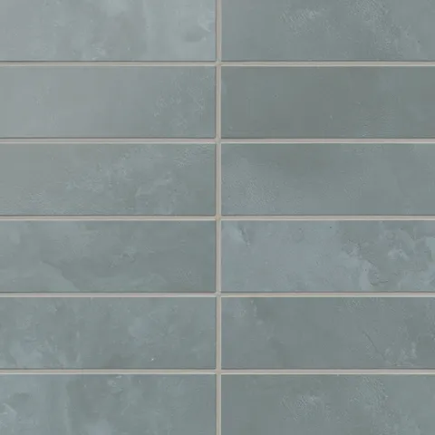 Blue 2x6 matte subway tiles carry gentle, earth-drawn variation and a powdery surface look, laying out in an easy horizontal rhythm for backsplashes and walls.