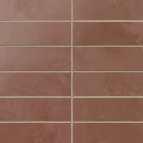 Earthy red 2x6 matte porcelain subway tiles form a clean, horizontal layout, with soft texture that gives backsplashes and accent walls a calm, tactile feel.