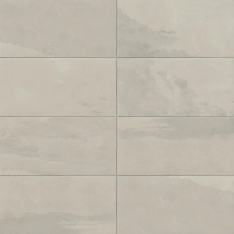 Matte rectangular tile in earthy gray tones with natural stone look, ideal for adding warmth and texture to contemporary, rustic, or transitional spaces.