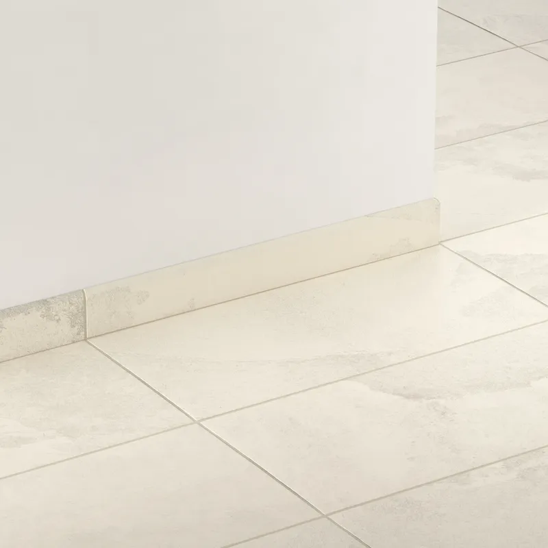 Matte bullnose tile in off-white and soft beige tones with stone-like variation, providing a clean and cohesive floor-to-wall transition for bright, modern spaces.