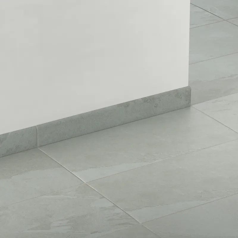 Matte bullnose tile in gray and soft blue tones with subtle stone-like texture, ideal for seamless edge finishing on walls, backsplashes, or tub surrounds.