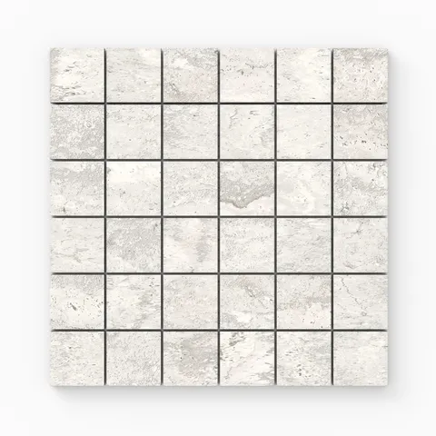 Light gray travertine-look porcelain 2x2 matte mosaic tile with delicate stone variation, soft veining, and a clean, timeless look.
