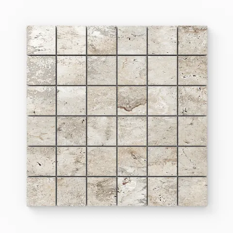 Warm beige travertine-look porcelain 2x2 polished mosaic tile with subtle veining, soft tonal shifts, and a luminous stone look.