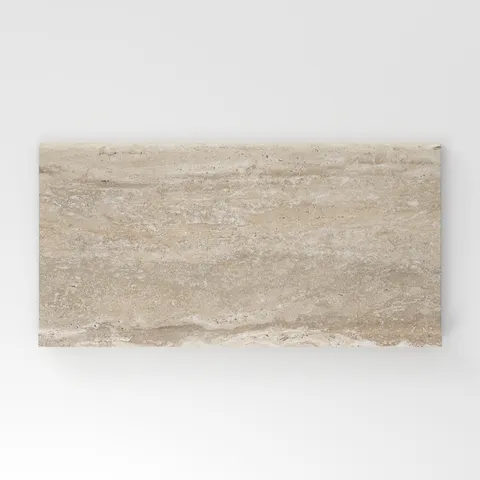 Beige travertine-look porcelain 6x12 cove base tile showcasing warm tones, gentle horizontal veining, and authentic stone character.