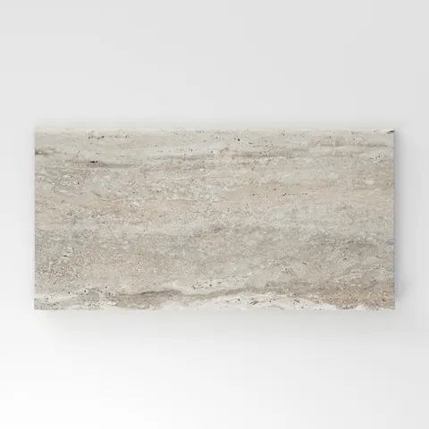 Cream travertine-look porcelain 6x12 cove base tile with soft linear veining, subtle movement, and a refined stone-inspired surface.