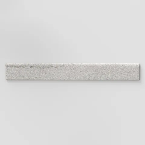 Elongated subway-style trim with a curved front edge, featuring subtle texture and layered light gray tones inspired by hand-formed clay.