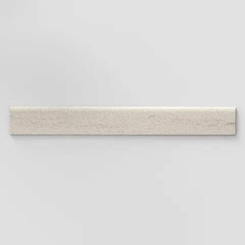Elongated subway-style trim with a curved front edge, featuring a subtly textured surface and grayish beige tones.