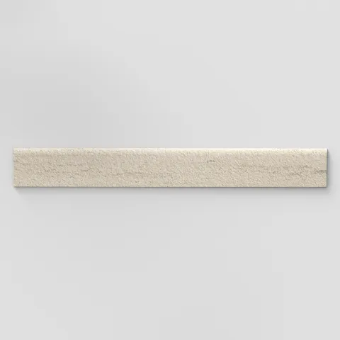 Elongated subway-style trim with a curved front edge, featuring a subtly textured surface and layered warm beige tones inspired by hand-formed clay.