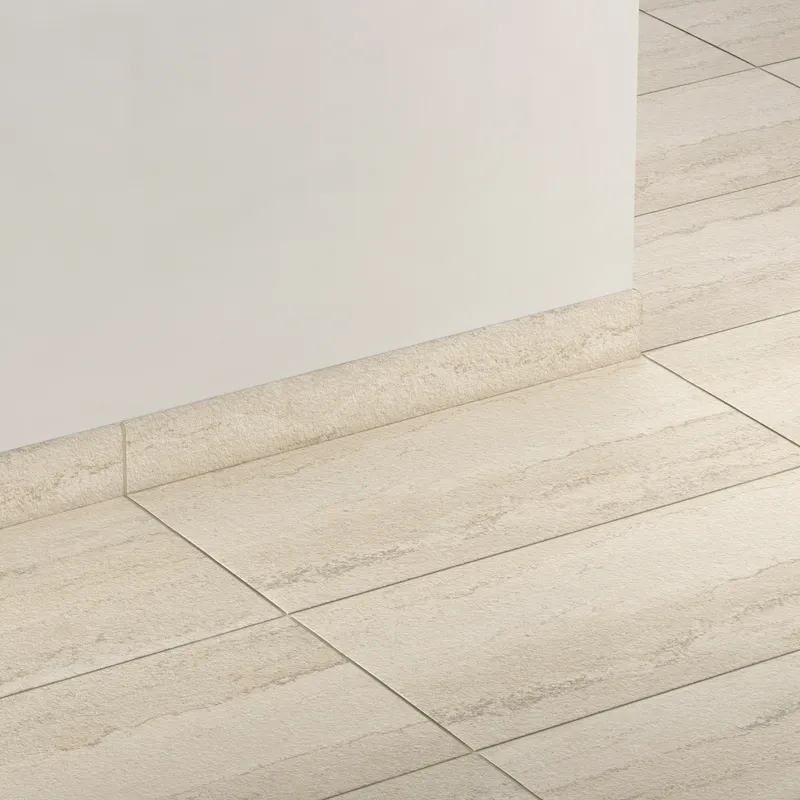 Elongated subway-style trim in warm beige with a subtly textured surface, creating a smooth transition between wall and floor.