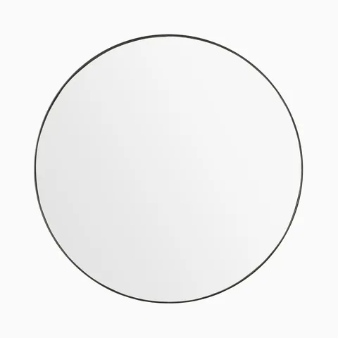 Minimalist round mirror with a slim rustic black frame, offering timeless versatility.