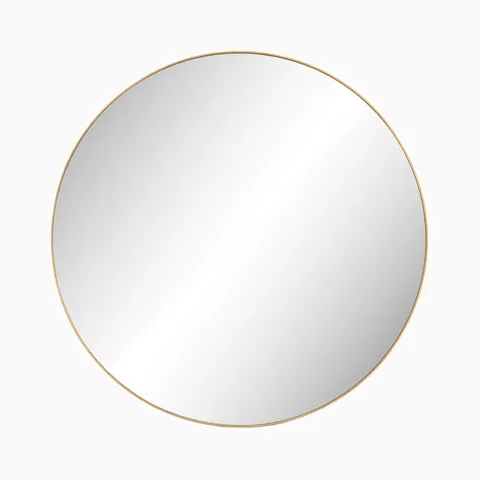 Elegant round mirror framed in polished brass, adding warmth and refinement to any space.