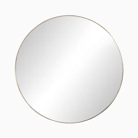 Round mirror with a polished brass frame made from aluminum, radiating understated elegance ideal for both classic and contemporary interiors.
