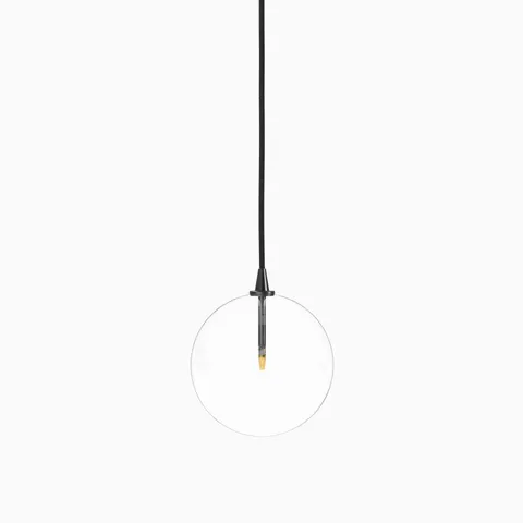 Minimalist pendant light with a clear glass globe, suspended by a black gunmetal cord and featuring a slim black and brass vertical socket.