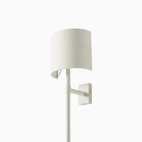 Textured matte white plaster wall sconce with a minimalist semi-cylindrical shade and seamless silhouette.