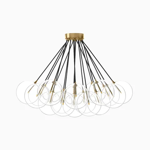 Modern chandelier with burnished brass canopy and clear glass globes hanging from black cords in a sculptural array.