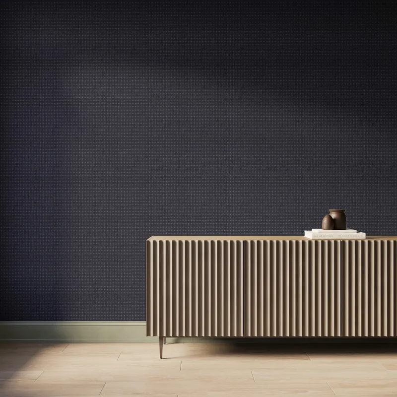 Modern interior featuring charcoal crosshatch wallpaper that creates a subtle woven texture, paired with a fluted wood console cabinet, light wood flooring, and soft natural light casting gentle shadows across the wall.