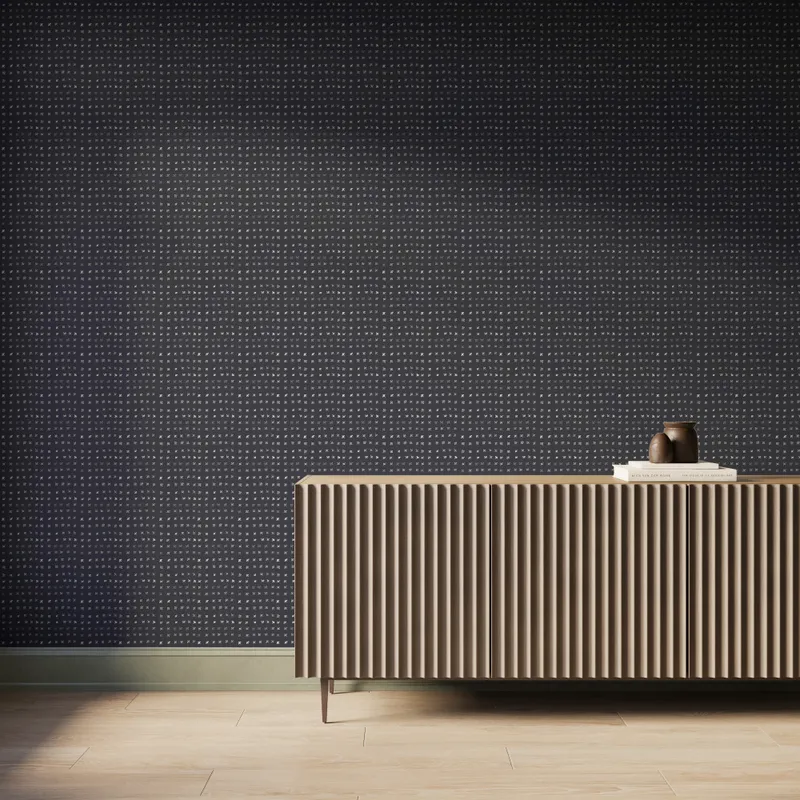 Black Somerset Wallpaper in Black II with small off-white watercolor-style motifs creating a subtle repeating pattern behind a ribbed wood console.