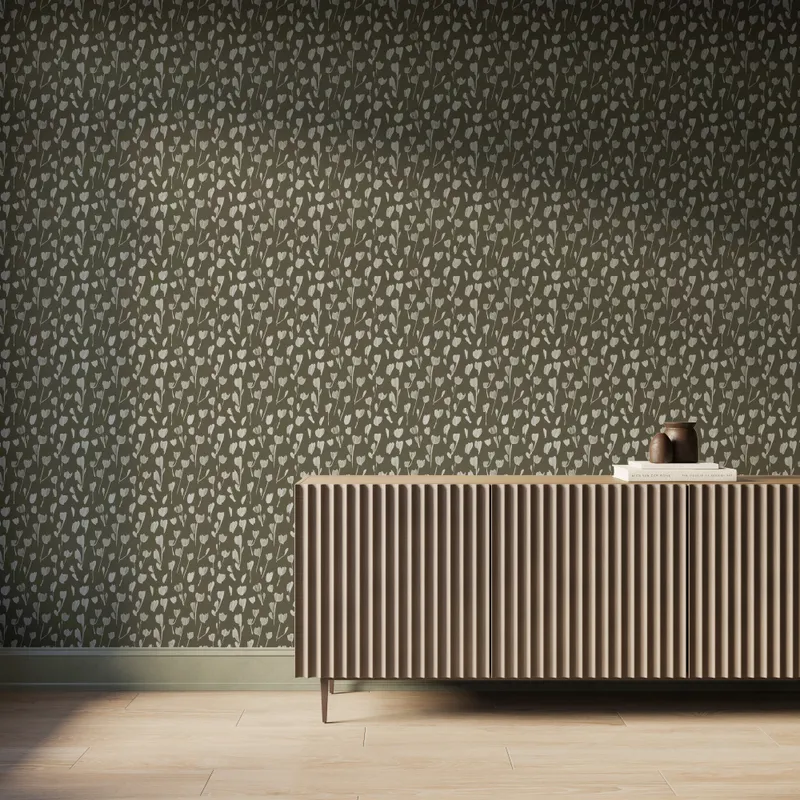 Petaline wallpaper Olive II creates an earthy backdrop with off-white floral silhouettes over olive green behind a fluted wood console, fitting organic interiors.