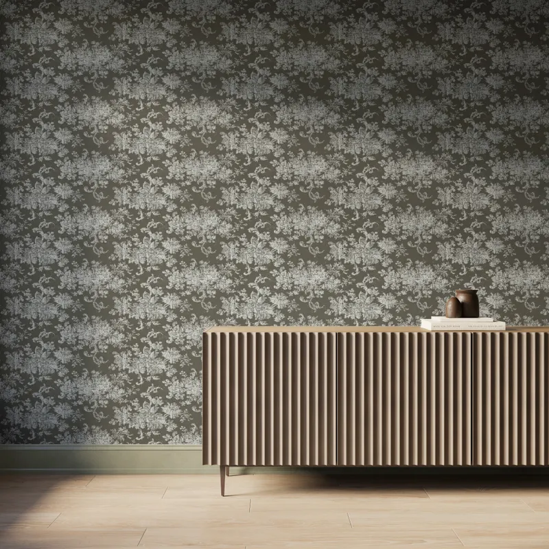 Interior scene featuring Brocade Wallpaper in Olive I with a white damask floral motif over a matte olive green background, styled with a fluted wood console cabinet, decorative books and vases, and light wood flooring under soft natural light.